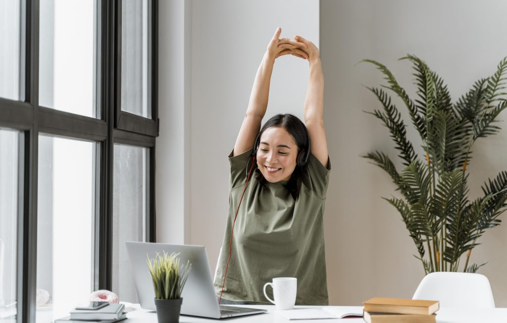 woman stretching about to go to the wellness room at work